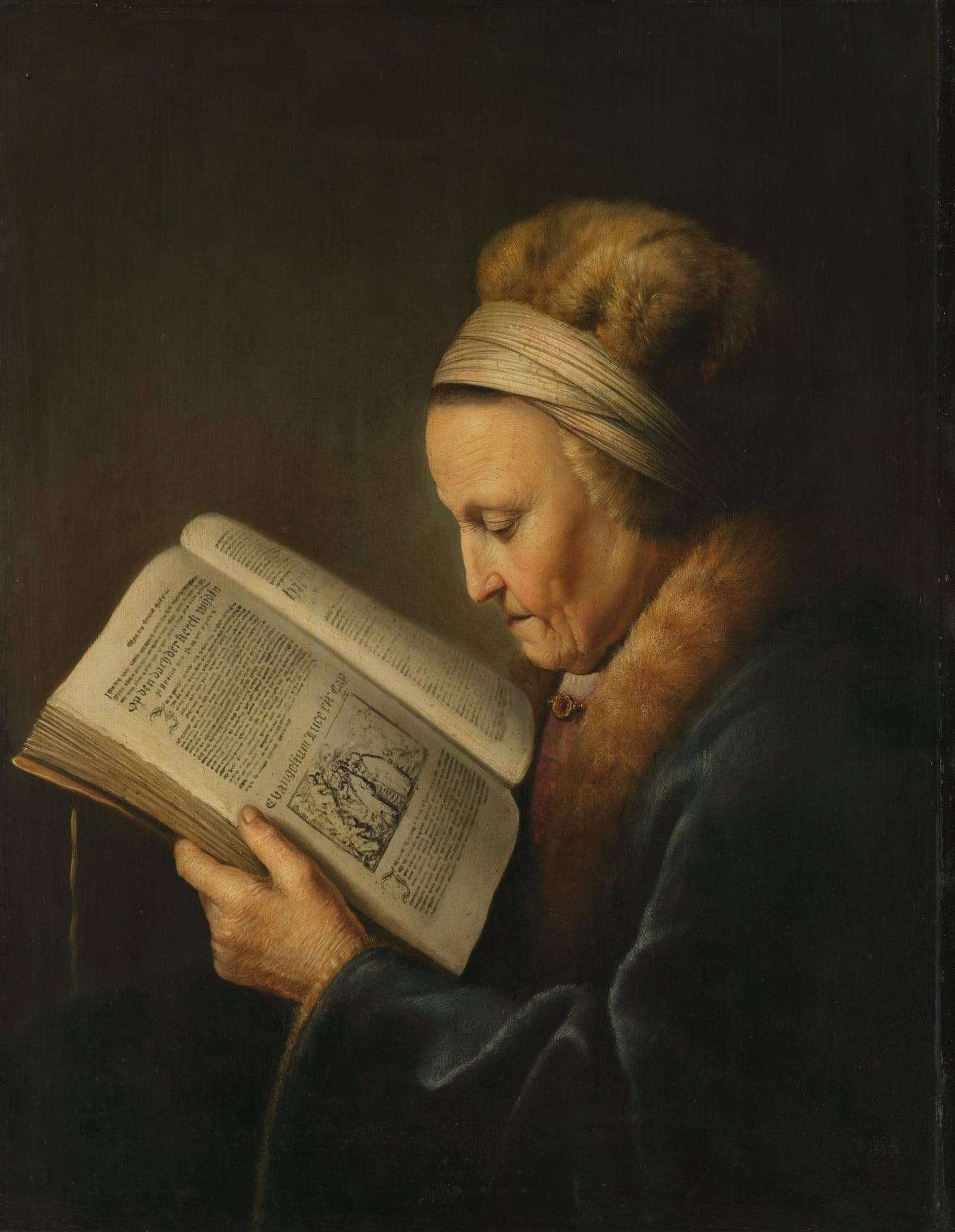 Gerard Dou’s painting of an elderly woman in a fur hat and fur-collared dark blue robe, reading in profile from a large open book held in her hands, its pages showing dense printed text and a small woodcut.